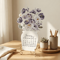 Decorative calendar with floral design on a wooden table