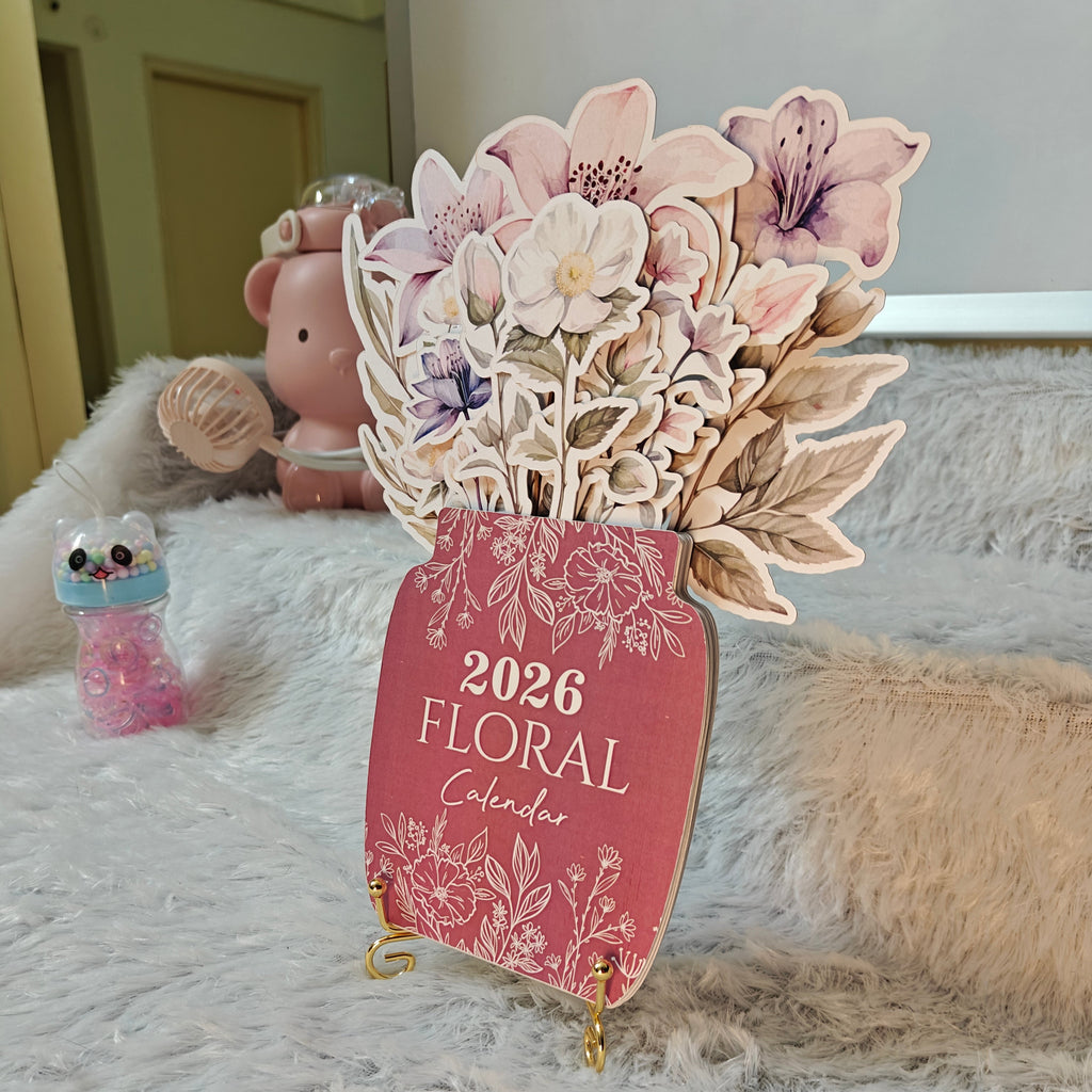 Floral-themed calendar with decorative flowers on a soft surface